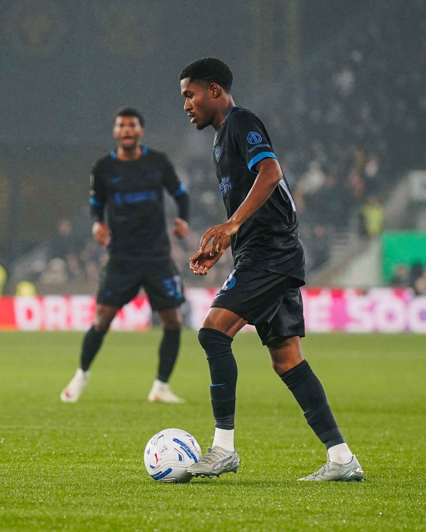 A Portsmouth player keeps possession during the Championship clash with Wolves.