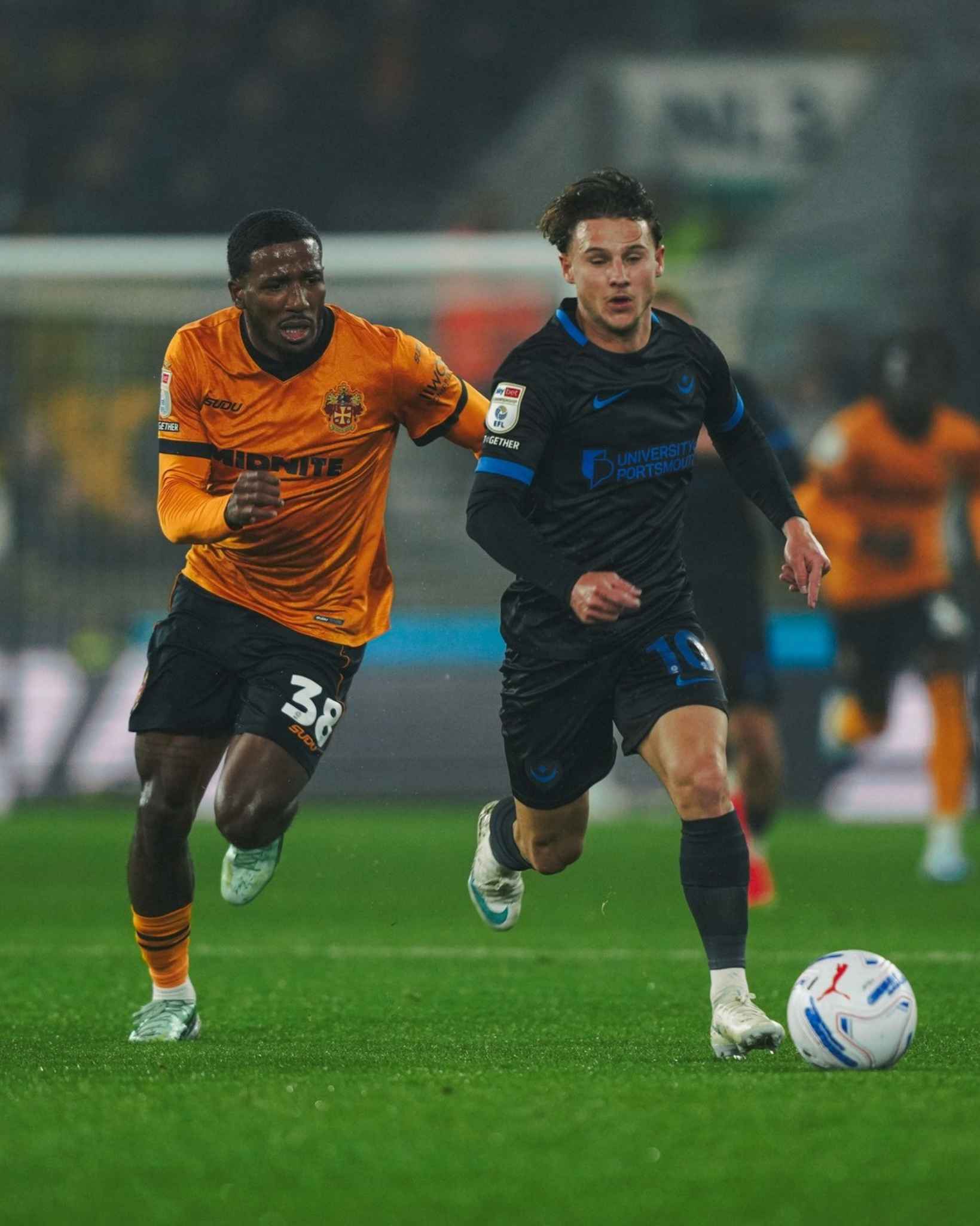 The two sides compete for the ball during an intense moment of the match.