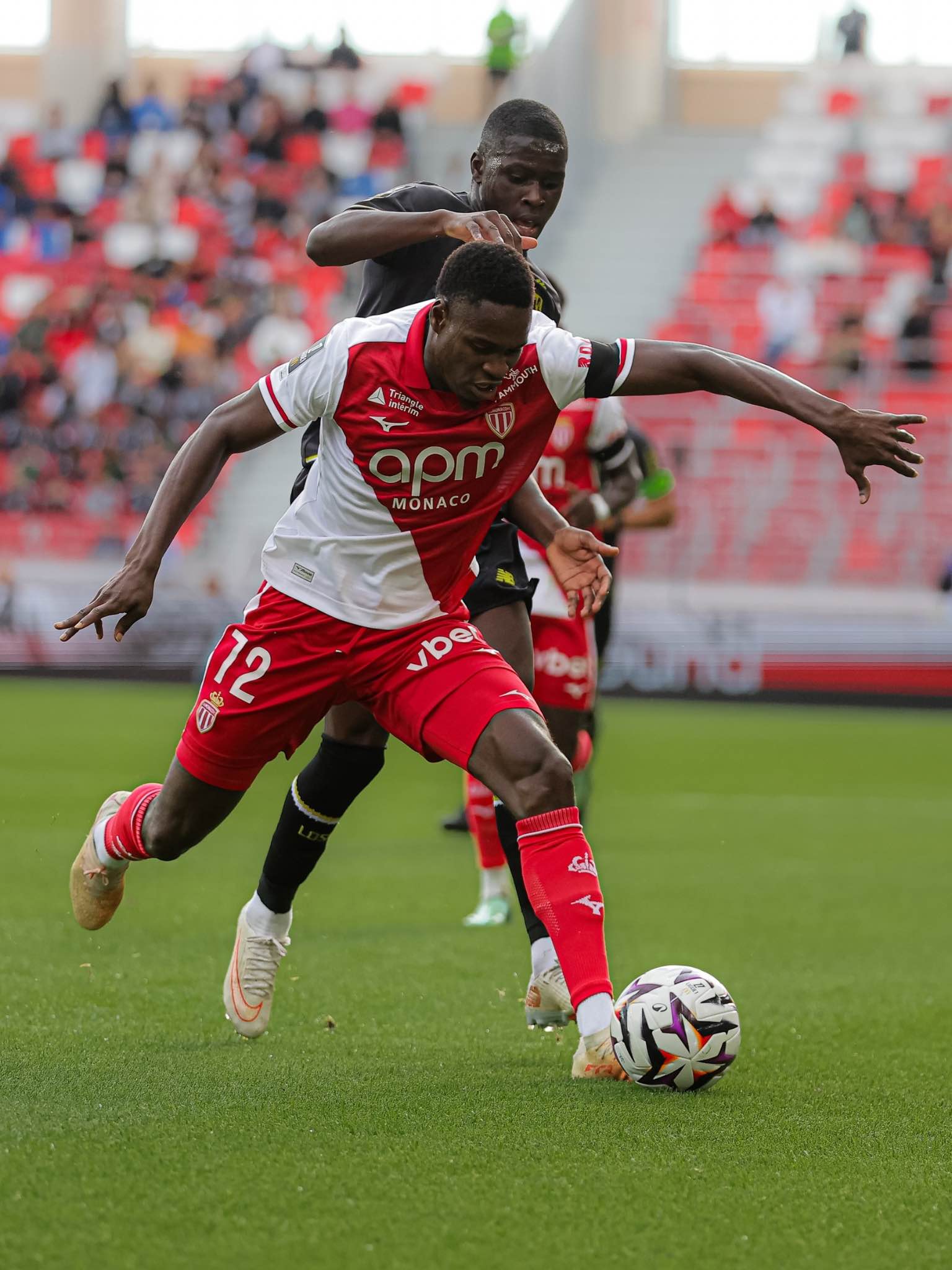 Monaco’s player fights to control the ball under pressure.
