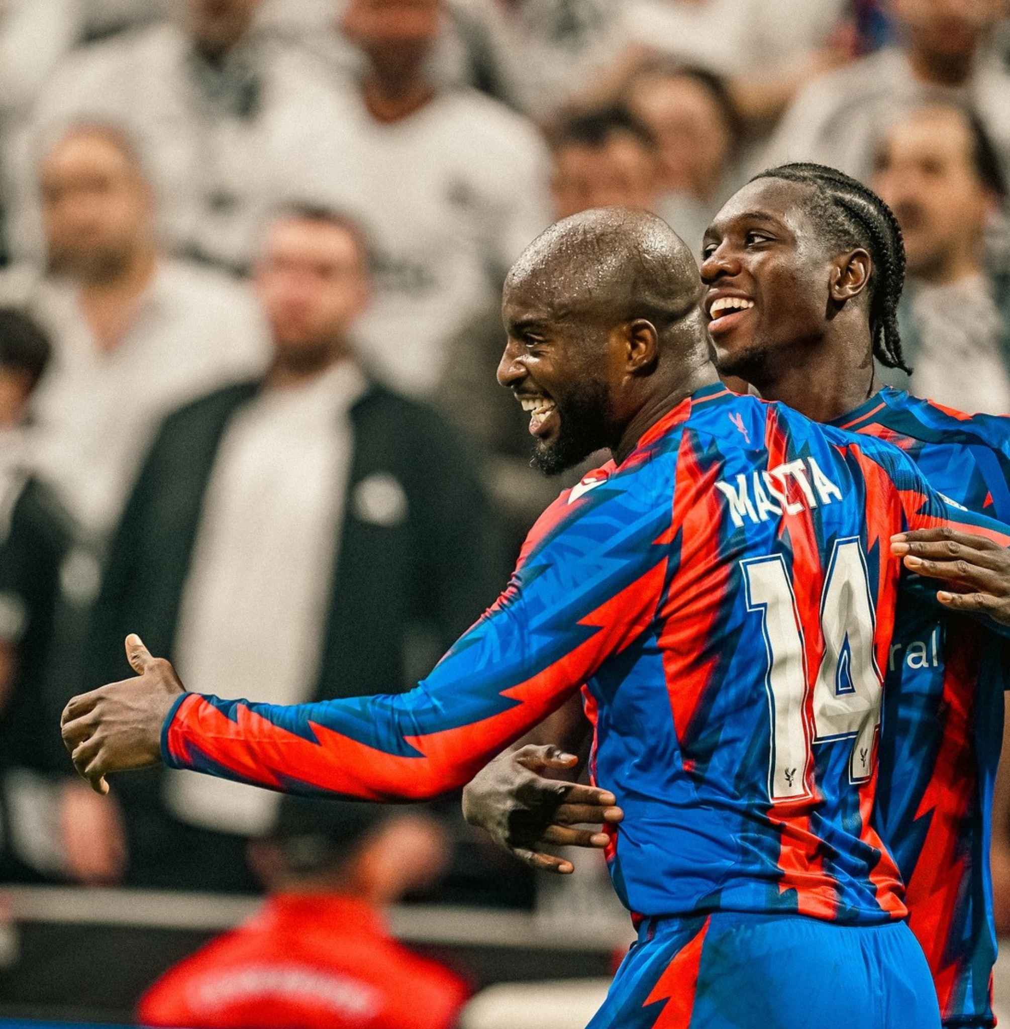 Crystal Palace players celebrate together after scoring.