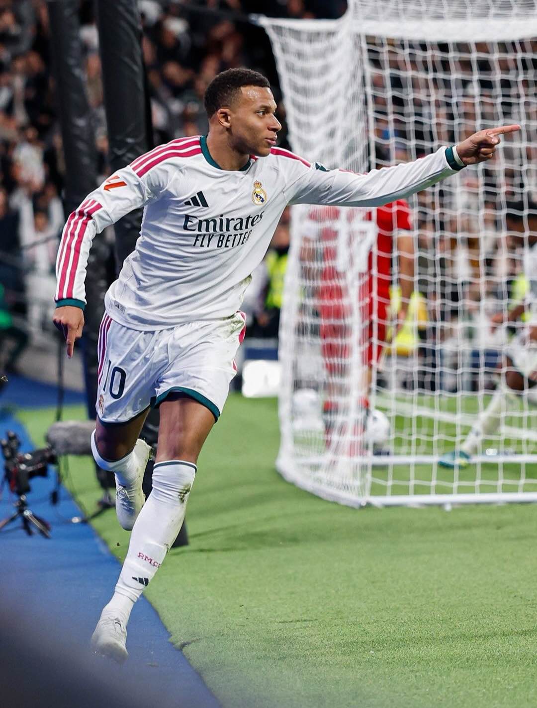 Kylian Mbappé points toward the crowd during his celebration after finding the net.