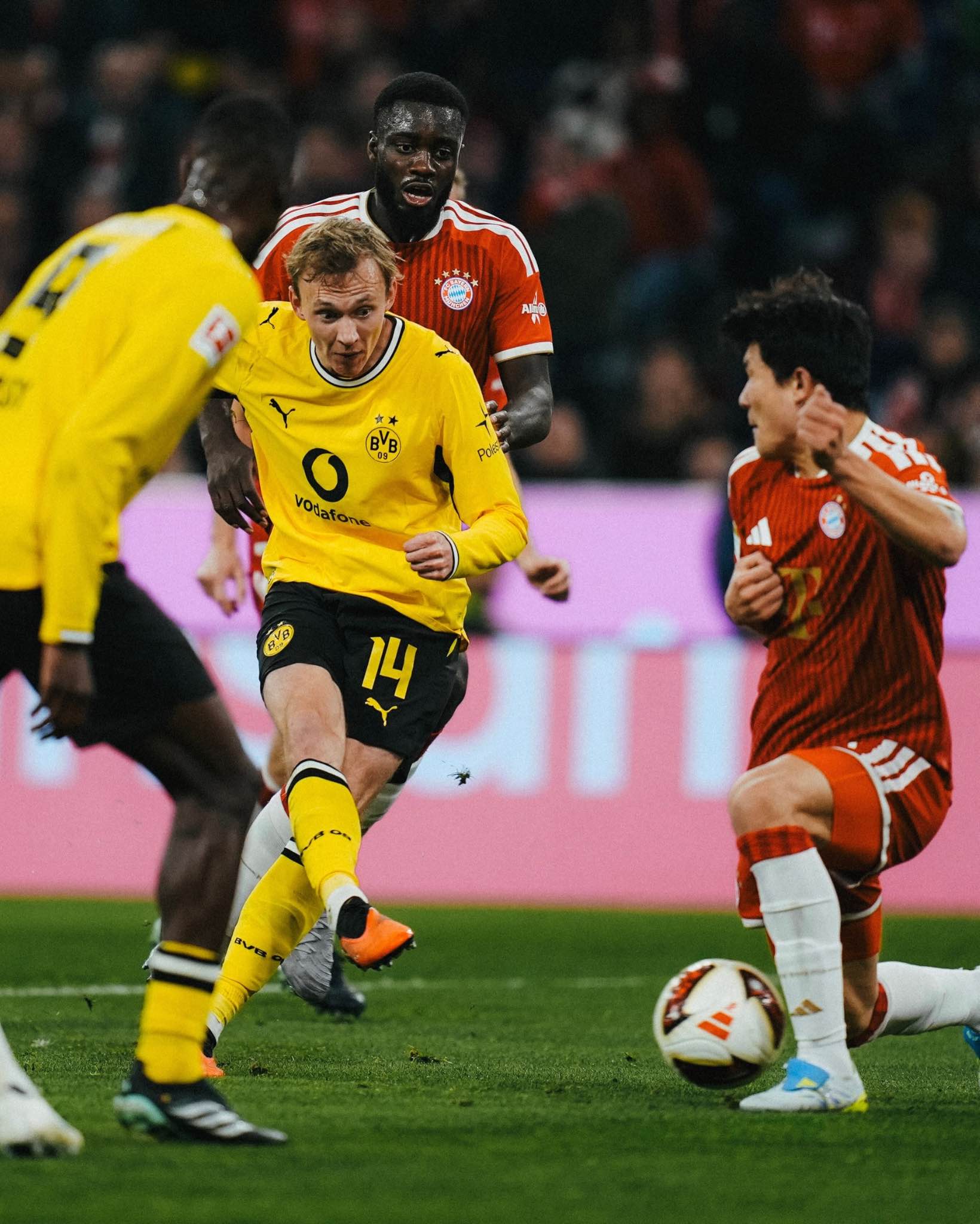 Bayern Munich and Borussia Dortmund players compete during their thrilling 2-2 Bundesliga draw.