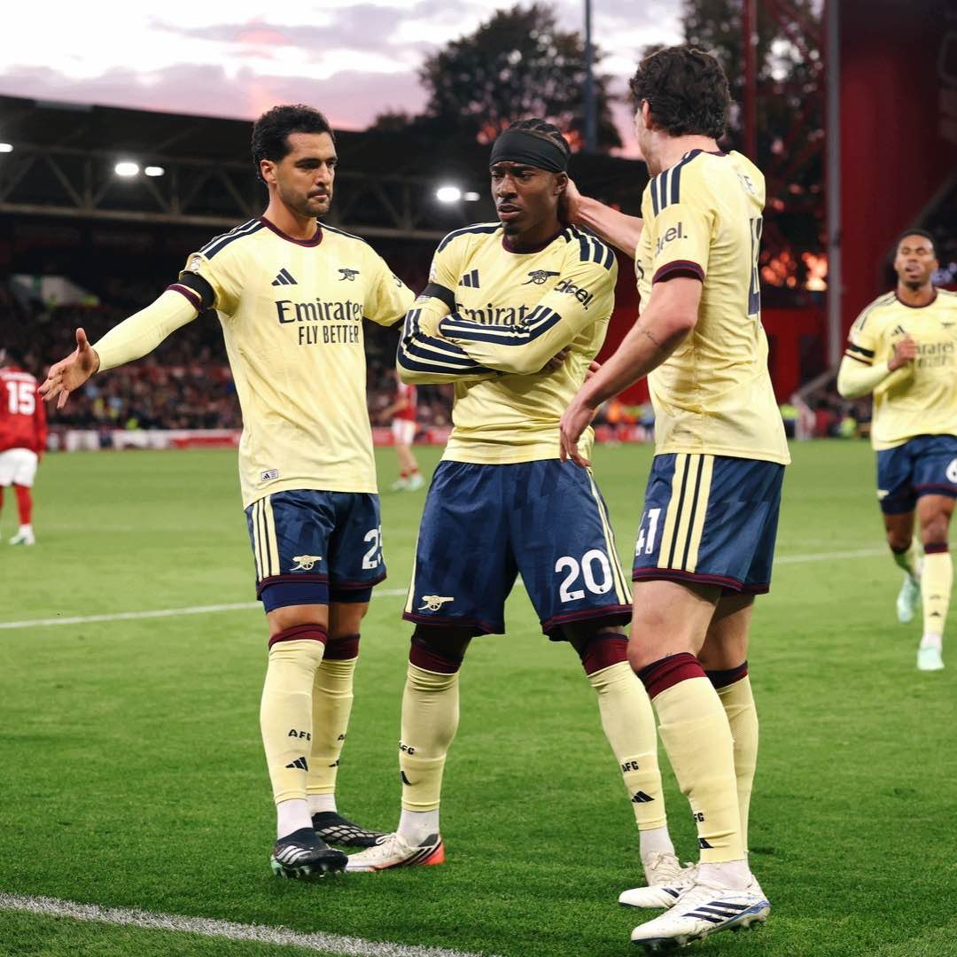 Arsenal players celebrate with Madueke after his decisive goal.