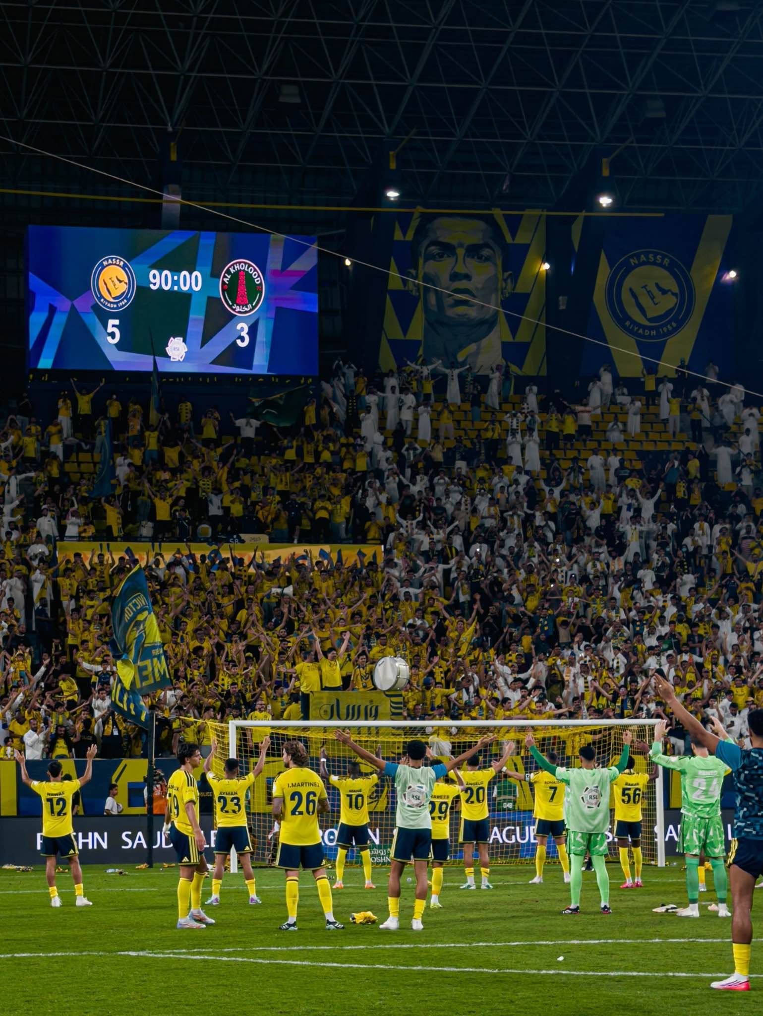 Al Nassr players celebrate in front of their supporters following the victory over Al Kholood.