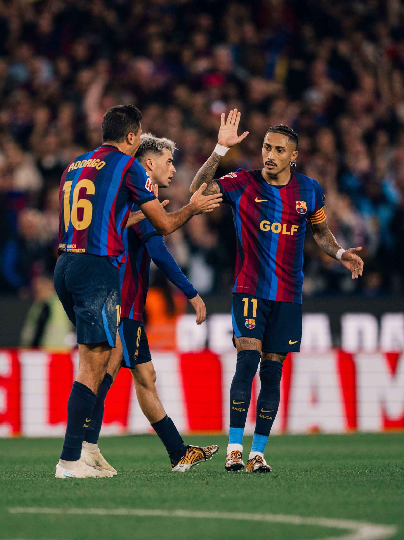 Raphinha celebrates with his teammates during the match.