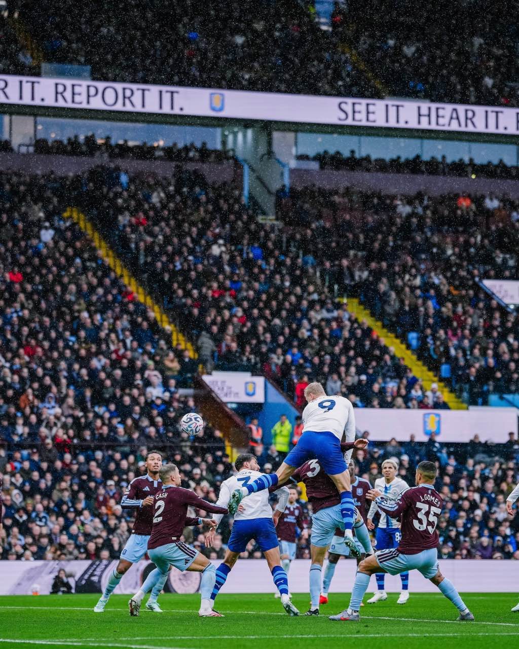 Erling Haaland competes for the ball during the rain-soaked clash.
