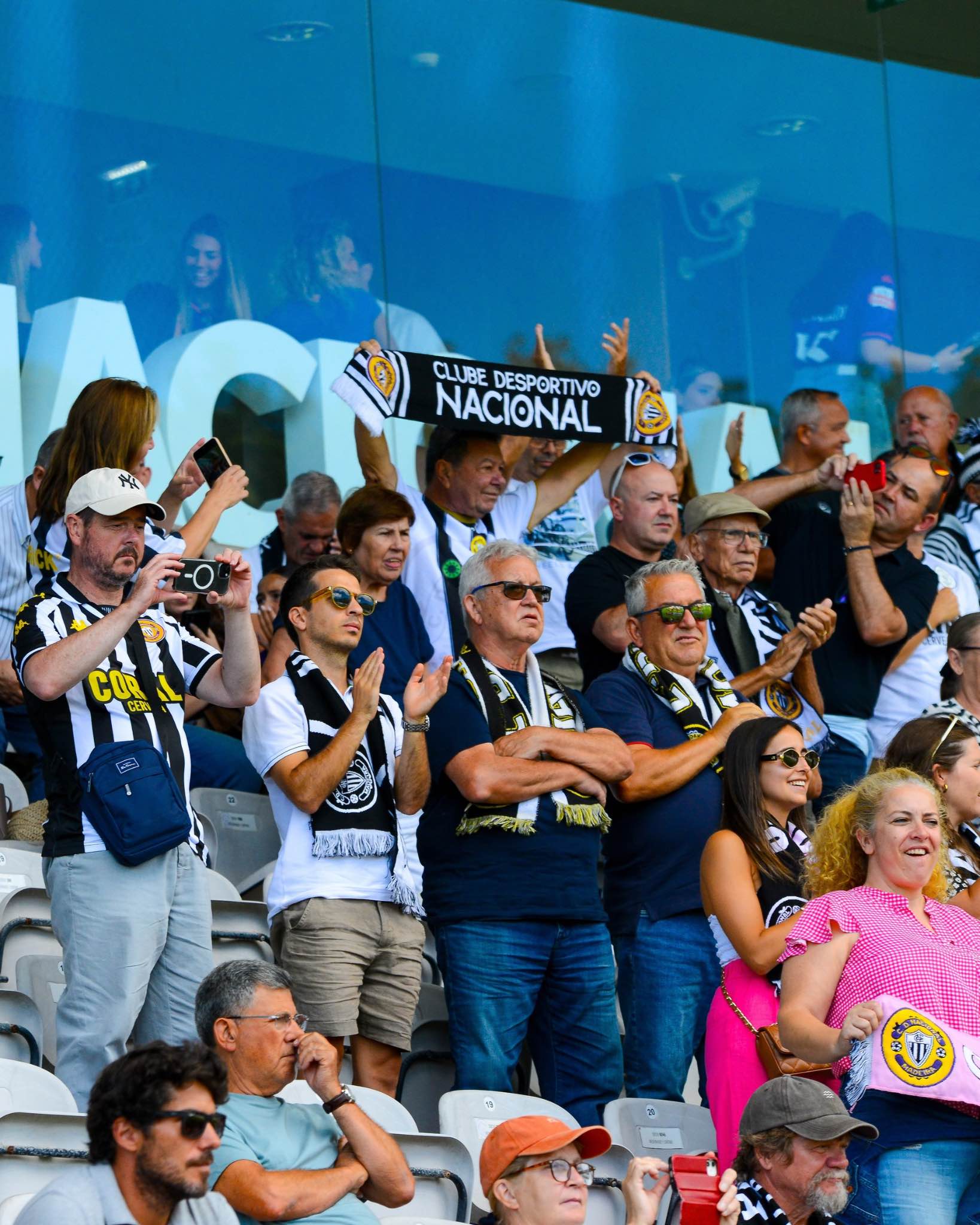Supporters of Nacional cheer and show their colours during the match.