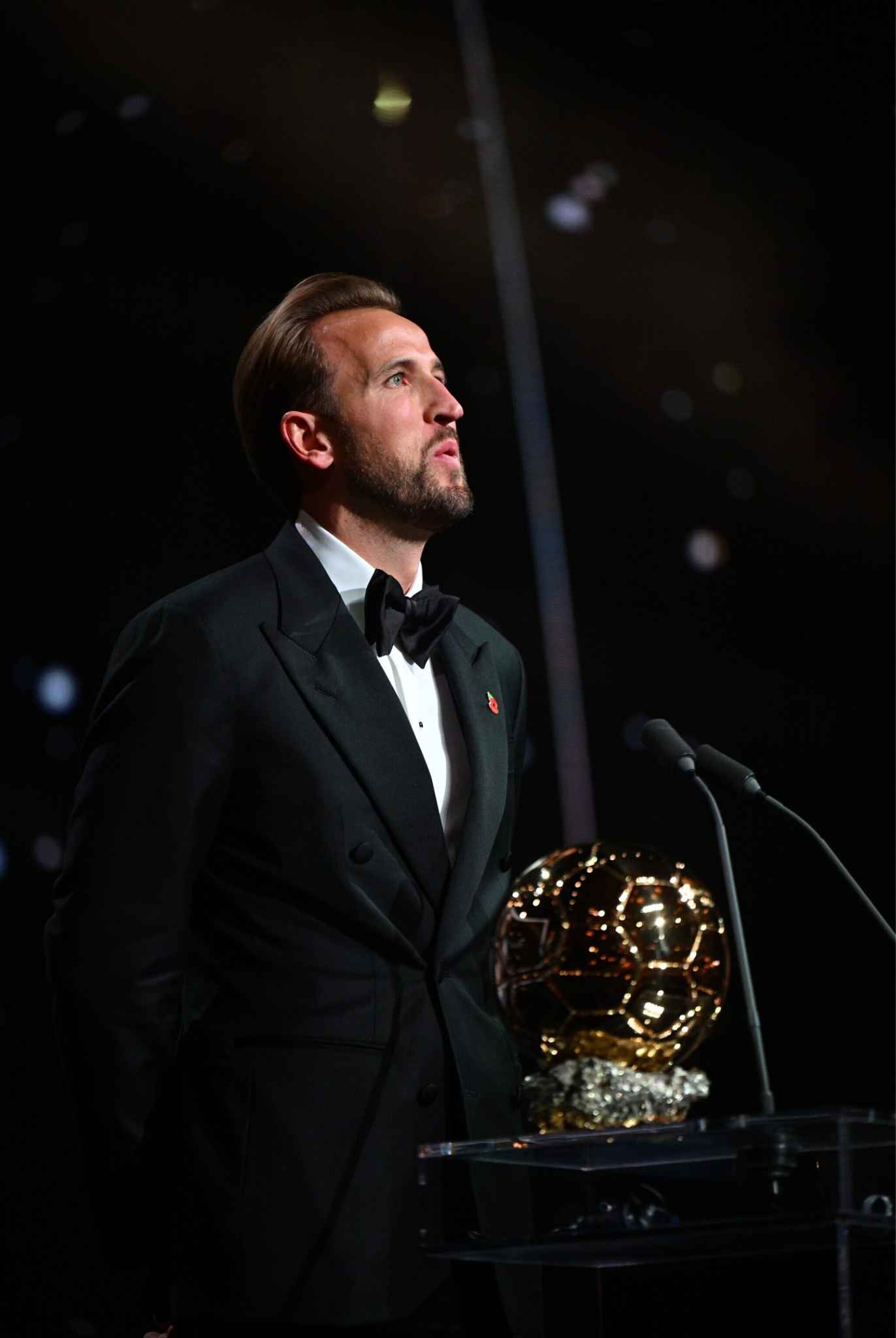 Kane stands beside the prestigious Ballon d’Or trophy during his unforgettable celebration.